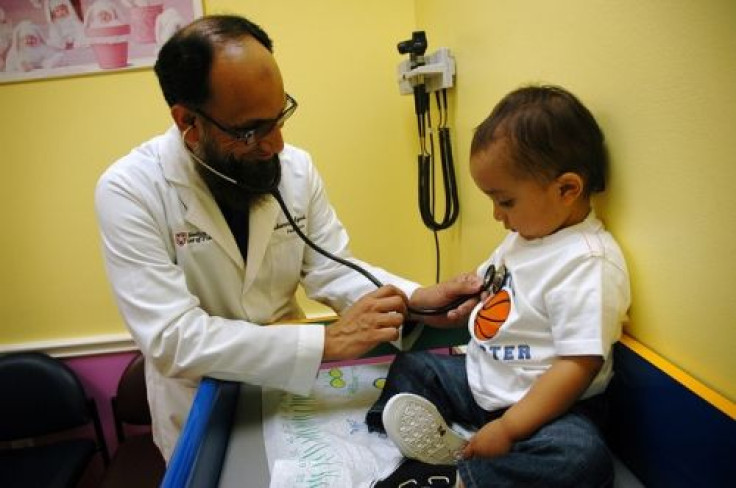 A pediatrician examins a boy.