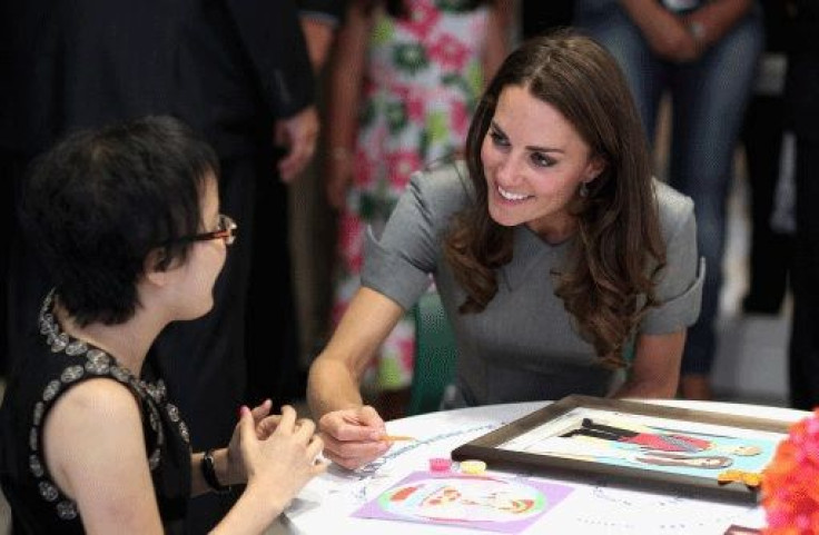 Kate Middleton, the Duchess of Cambridge talks to a young girl in a children's cancer ward as she visits Sainte-Justine University Hospital, in Montreal, Canada.