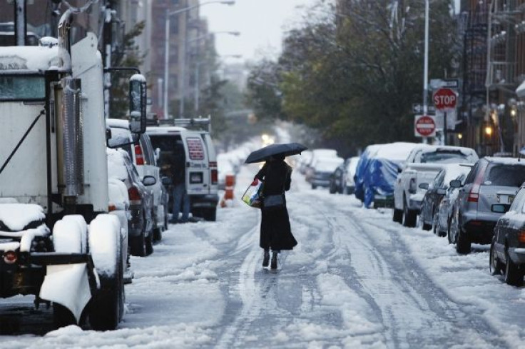 A woman walks down a snow-covered street