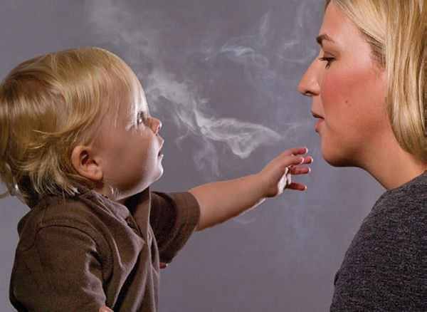 This handout image, released on November 10, 2010 depicts a mother blowing cigarette smoke in a child's face in one of the Federal Drug Administration's proposed new "graphic health warnings." Diseased lungs, dead bodies, a man on a ventilator a