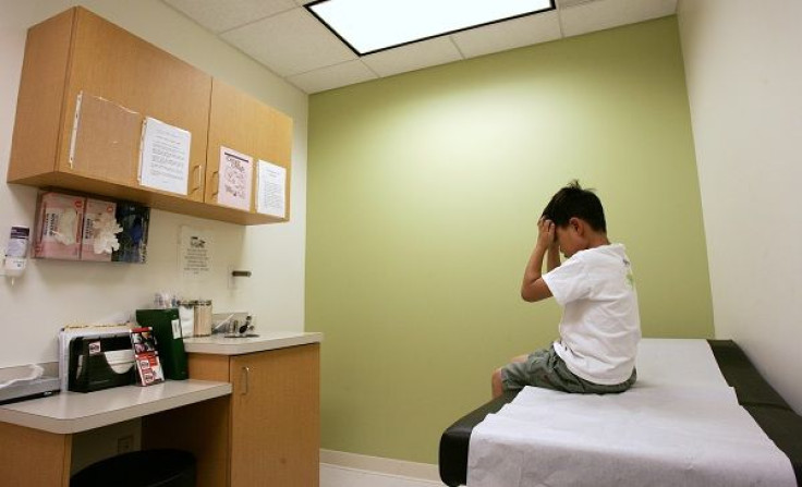 A six-year-old boy patient at Capital Area Pediatrics office in Ashburn, Virginia waits to see a doctor, July 29, 2009.