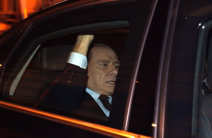 Italy's outgoing Prime Minister Silvio Berlusconi leaves after the vote for the package of economic reforms intended to reverse a collapse of market confidence at the lower house of the Parliament in Rome November 12, 2011.