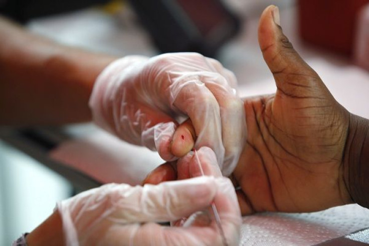 A medical technician draws a blood sample to screen for glucose and cholesterol at a free health screening as part of the National Urban League's Economic Empowerment Tour in Dallas, Texas June 13, 2009.