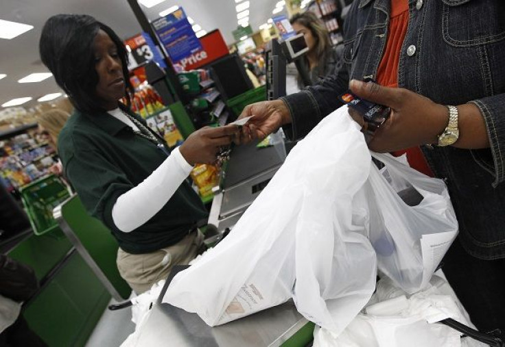 A shopper pays for her purchases in a newly opened Walmart Neighborhood Market in Chicago, September 21, 2011.