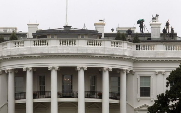 A crew works atop the White House