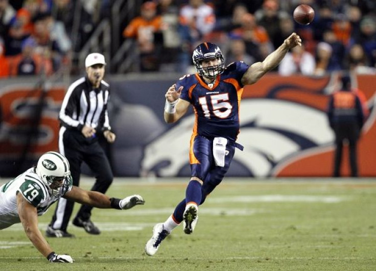 Denver Broncos quarterback Tim Tebow throws after escaping from New York Giants end Ropati Pitoitua in their NFL football game in Denver November 17, 2011