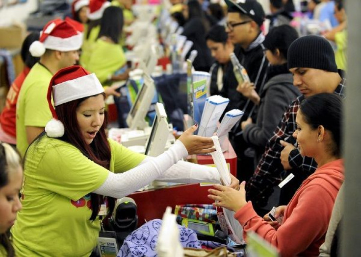 Shoppers pay for their purchases at an Old Navy store as &quot;Black Friday&quot; shoppers get an early start at the Citadel outlet stores on Thanksgiving in Los Angeles, California November 24, 2011.