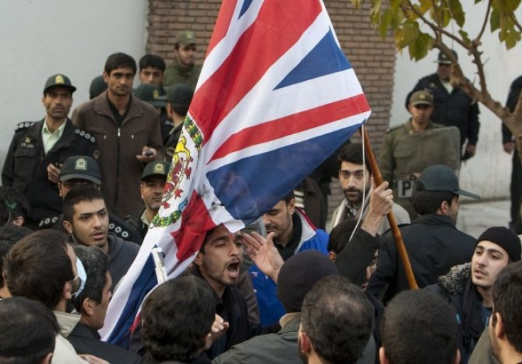 Protestors remove the flag of the British embassy in Tehran