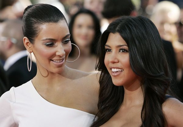 Reality star Kim Kardashian (L) and sister Kourtney Kardashian arrive on the red carpet at the 61st annual Primetime Emmy Awards in Los Angeles, California September 20, 2009.