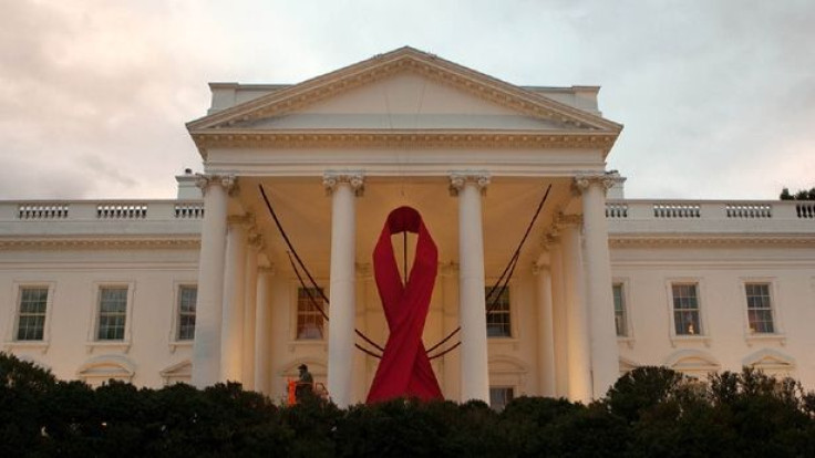 A red ribbon is hung from the North Portico of the White House to mark World AIDS Day,