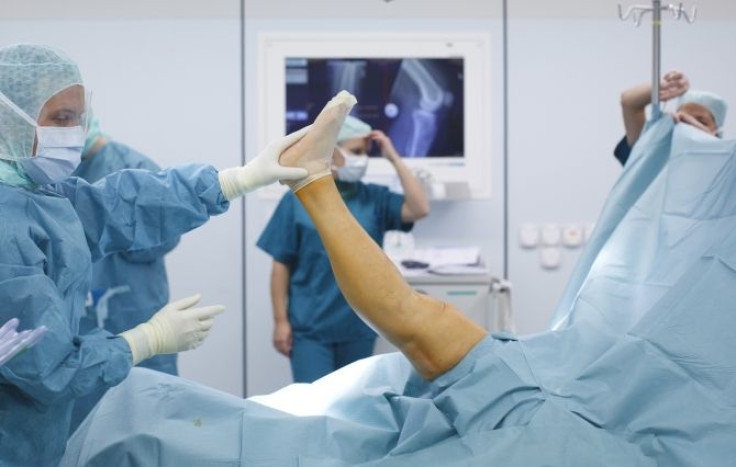 Doctors and medical staff work during knee prosthesis surgery