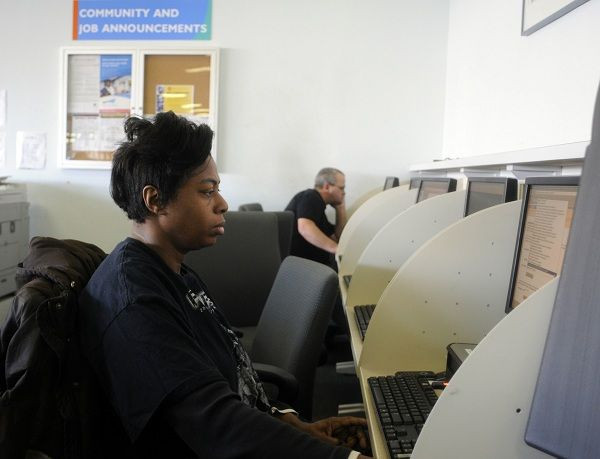 Carolyn Harden of Atlanta looks through job listings at the North Metro Department of Labor Career Center in Atlanta, Georgia, December 1, 2011.
