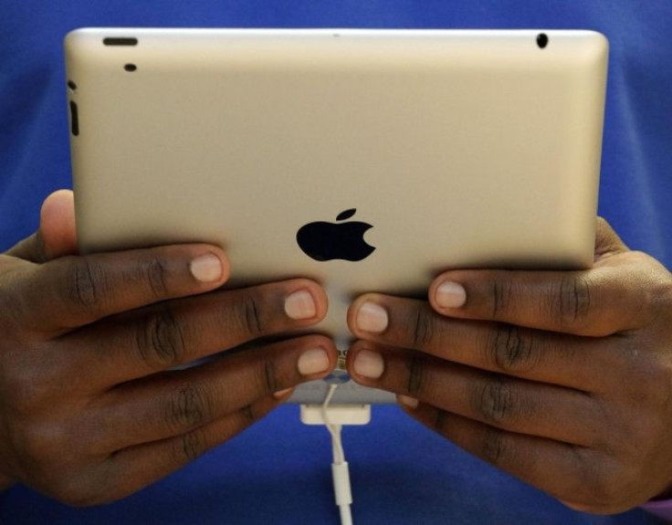 A staff member holds the new Apple iPad2.