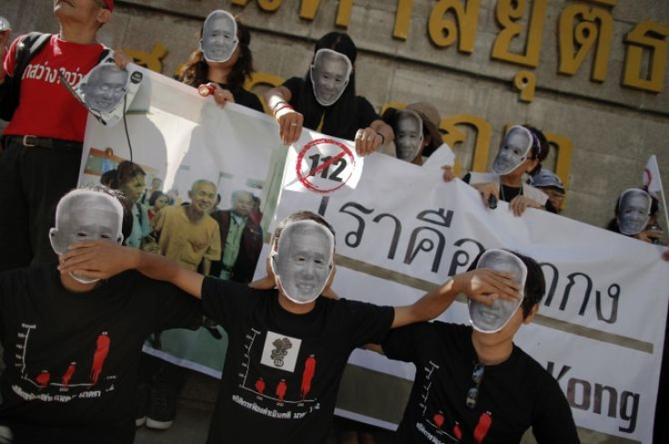 Protesters gather under the picture of Thailand's King Bhumibol Adulyadej outside the Criminal Court in Bangkok.