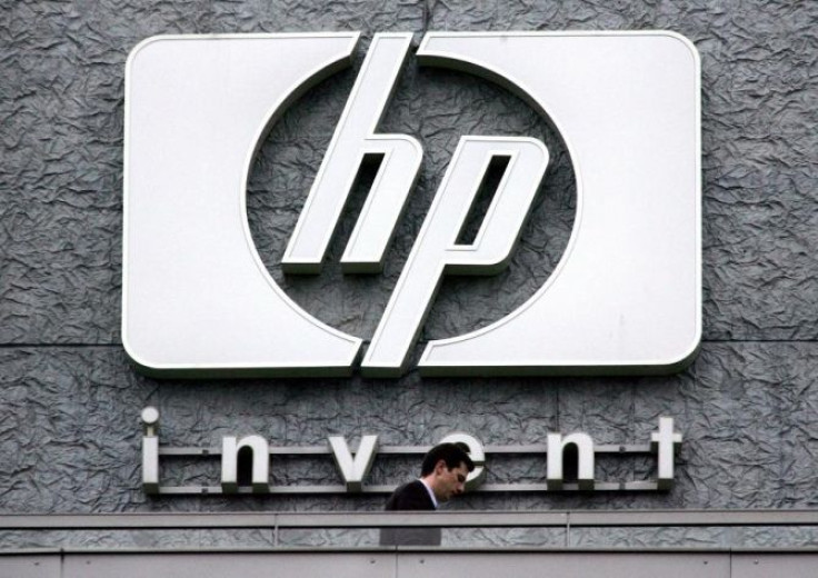 A man walks past the Hewlett Packard logo at its French headquarters in Issy le Moulineaux, western Paris, in this September 16, 2005 file photograph.