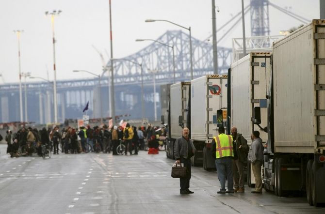 Truck drivers gather around their rigs at the Port of Oakland during the Occupy movement's attempts to shut down West Coast ports in Oakland
