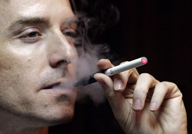 Scott Fraser, vice president of SBT (Holdings) Ltd., demonstrates an e-cigarette in Hong Kong.
