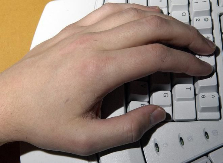 A tiny radio frequency identification (RFID) computer chip under the skin of Amal Graafstra's left hand logs him into a computer with a specially modified keyboard in New York January 4, 2006.
