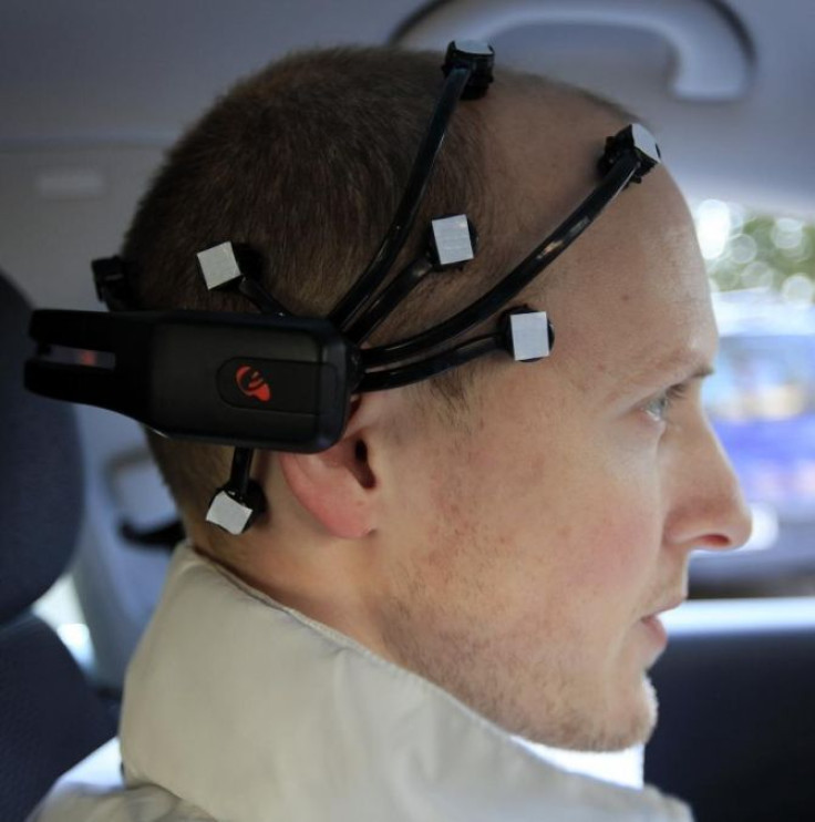 Daniel Goehring of the AutoNOMOS research team of the Artificial Intelligence Group at the Freie Universitaet (Free University) wears a Emotiv Epoc device as he demonstrates a hands-free driving of the research car named 'MadeInGermany' during a test in B