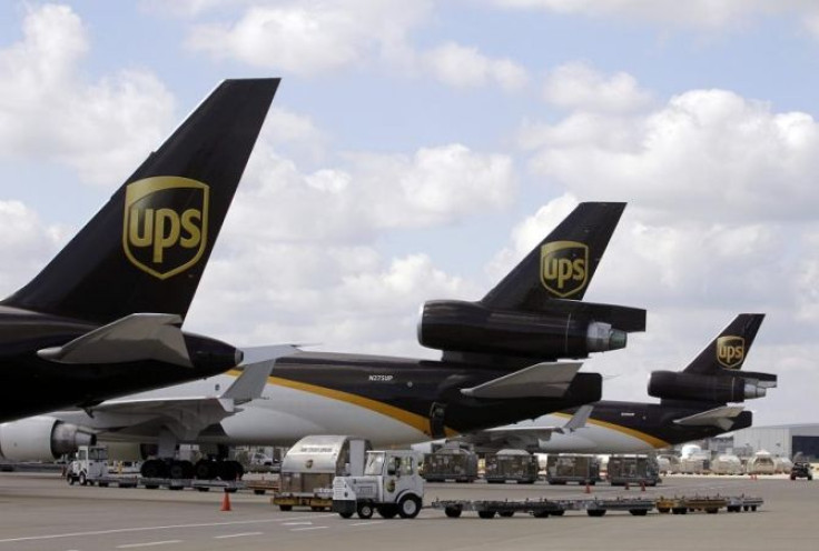 UPS employees load containers onto an aircraft at the World Port air hub during a visit by U.S. Treasury Secretary Timothy Geithner in Louisville, Kentucky September 26, 2011.