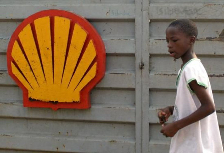 A Nigerian schoolboy walks past the logo of Dutch oil giant Shell near Warri in the volatile Niger-Delta region January 17,2006.