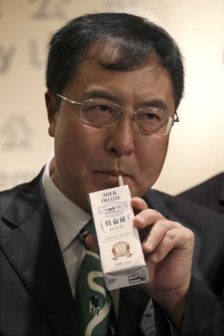 China Mengniu Dairy Executive Director and Chief Financial Officer Yao Tongshan drinks a packet of milk during a news conference announcing the company's annual results in Hong Kong September 8, 2009.