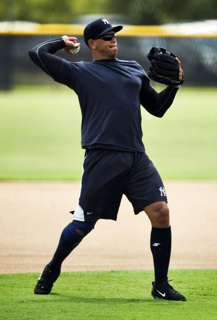 New York Yankees third baseman Alex Rodriguez throws during a light workout as he rehabilitates from knee surgery at the team's minor league complex in Tampa, Florida August 4, 2011.