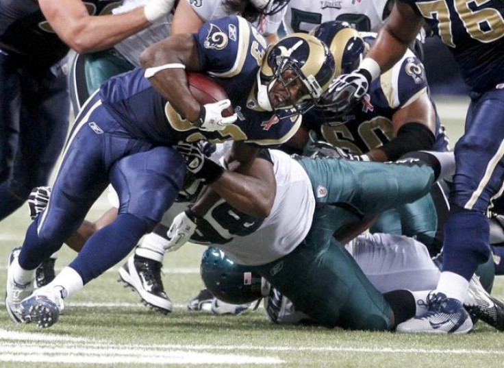 St. Louis Rams running back Cadillac Williams is tackled by Philadelphia Eagles defensive tackle Mike Patterson during the first half of their NFL football game in St. Louis, Missouri September 11, 2011.