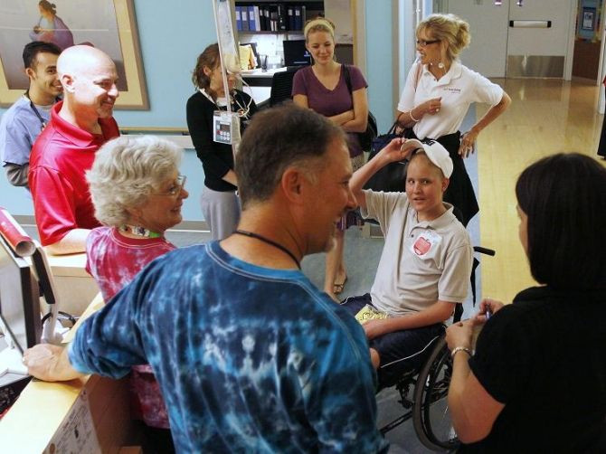 Mike Bamford (R), 17, reunites with staff at The Children's Hospital when he came in for treatment before going to a prom organised by The Children's Hospital for cancer patients, in Denver June 8, 2010.