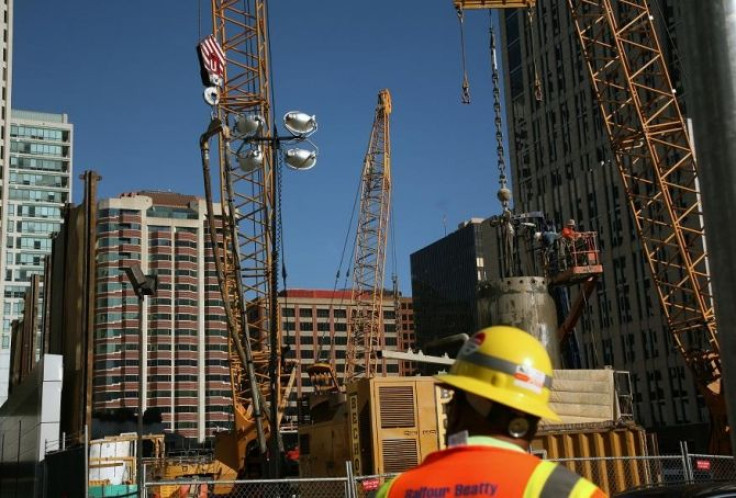 A worker stands in front of a construction site in San Francisco, California January 5, 2012.