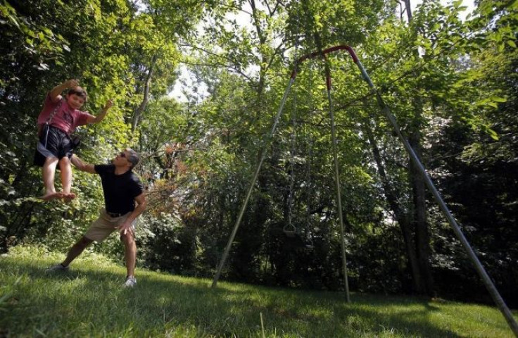 Ed Damiano pushes his son David on a swing in the family's backyard in Acton, Massachusetts July 23, 2011.