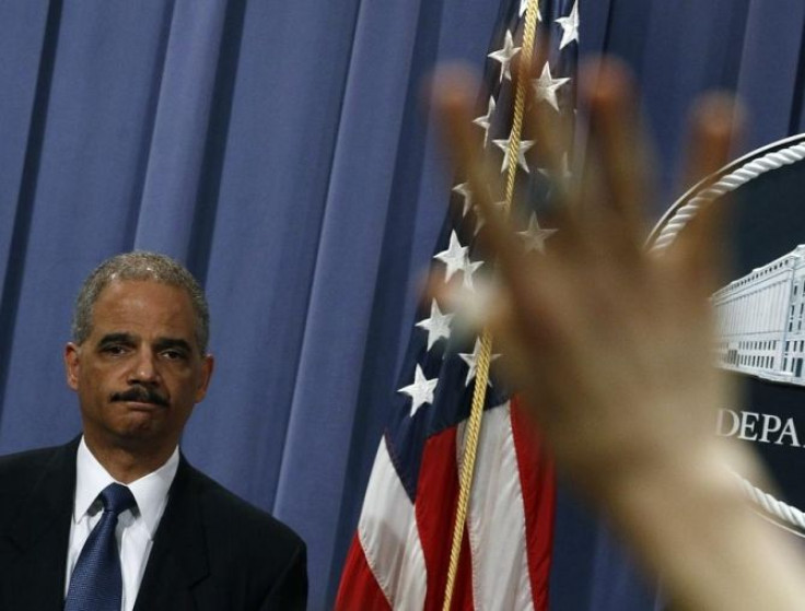 U.S. Attorney General Eric Holder listen to a question at a news conference to announce Medicare Fraud Strike Force law enforcement actions in Washington, February 17, 2011.