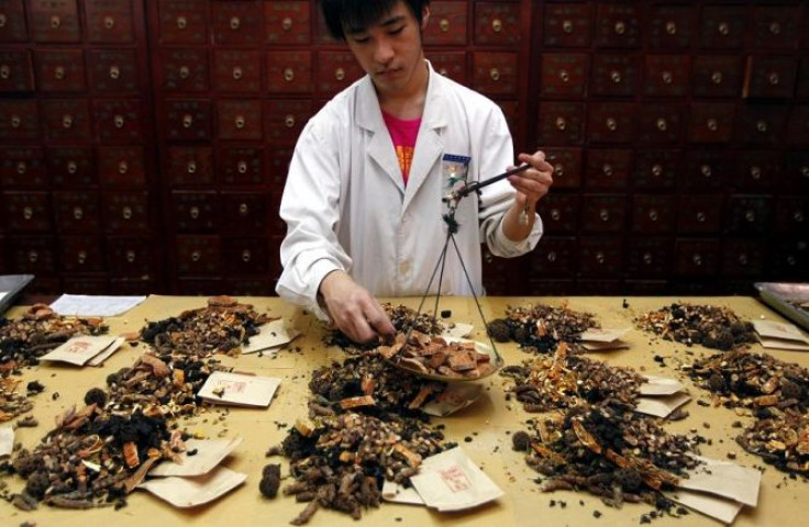 A worker prepares traditional Chinese herbal medicines at Beijing's Capital Medical University Traditional Chinese Medicine Hospital May 25, 2011.