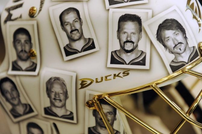 Pictures of the Anaheim Ducks' team with funny moustaches are seen on goalie Jonas Hiller's mask as part of a charity effort in Washington, October 31, 2011.