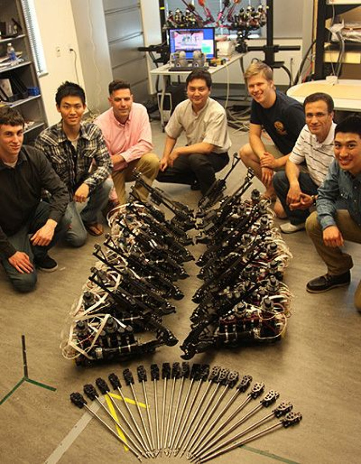 Team members posed with components of the Raven II surgical robotic systems developed in the Bionics Lab at the Baskin School of Engineering