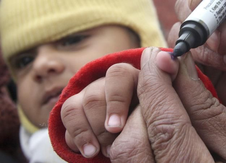 A health worker marks the finger of a child after administering a polio vaccine at a polio booth in the northern Indian city of Chandigarh January 10, 2010.