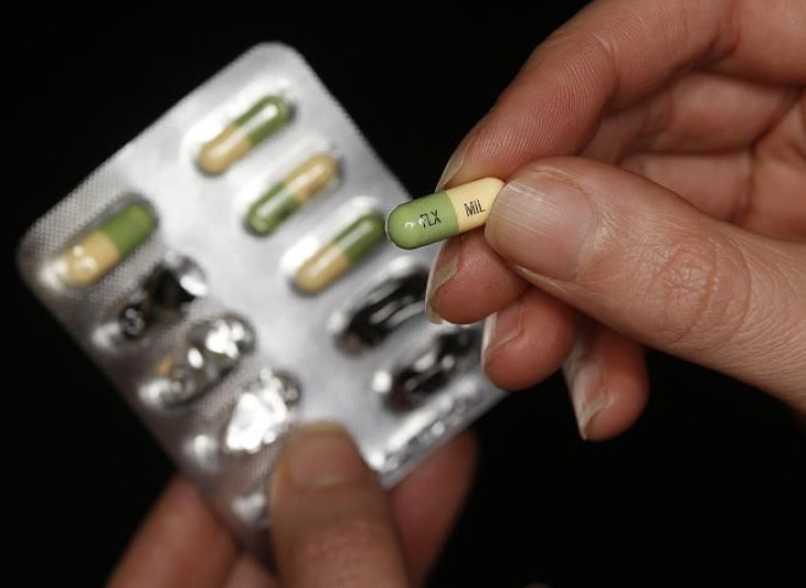 A woman holds a packet of the antidepressant drug Prozac, also known as fluoxetine.