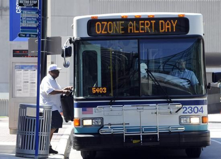 A passenger enters a Kansas City Metro bus that warns of an Ozone Alert in Kansas City, Missouri, August 1, 2011.