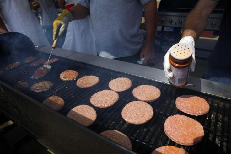 Volunteers cook hamburgers for tornado victims and workers in a supermarket parking lot in Joplin, Missouri May 27, 2011.