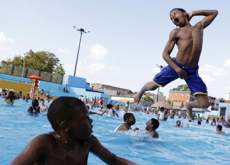 A boy jumps into the water at Kosciuszko Pool in Brooklyn on a hot summer day in New York July 12, 2011.