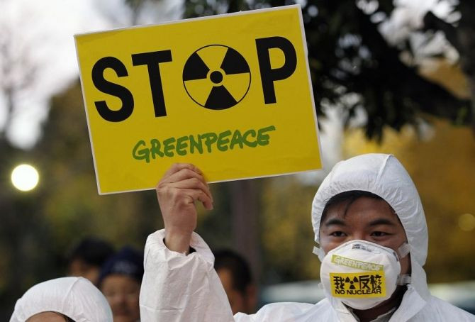 A Greenpeace activist holds a placard during a demonstration outside Japan's Prime Minister Yoshihiko Noda's official residence in Tokyo, criticizing the government's declaration of cold shutdown at the Fukushima nuclear power plant December 16, 2011.