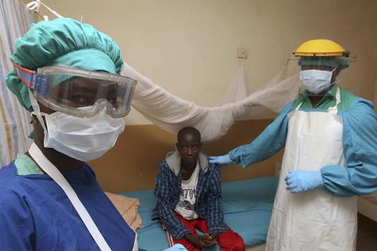 Sierra Leonean nurse Veronica Koroma (L) and doctor Donald Samuel Grant (R) stand by a patient in the Lassa fever ward at Kenema Government Hospital in southeastern Sierra Leone February 7, 2011.