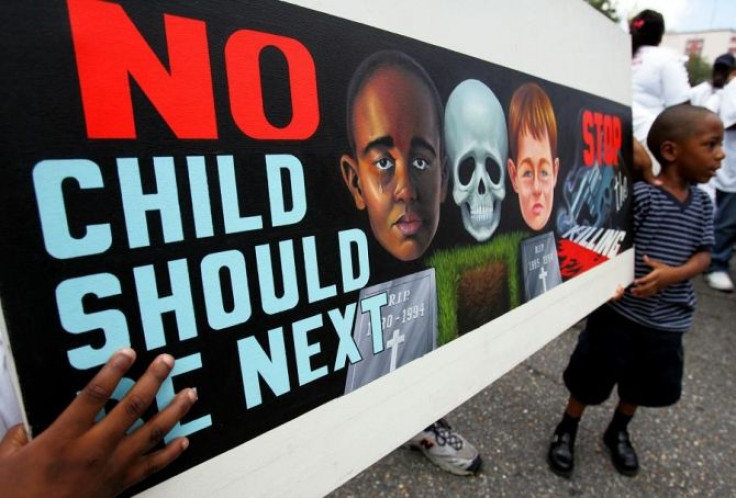 Kentrel Smith, 4, carries a sign protesting the violence in New Orleans as he and others march through central city while carrying signs during the 7th annual Central City Youth Against Violence