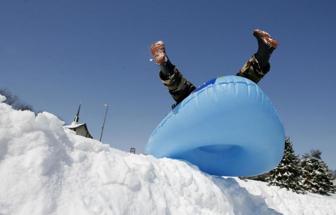 Clayton Meyer, 10, takes advantage of the heavy snow to ride his sled in Newark, Ohio, March 9, 2008.