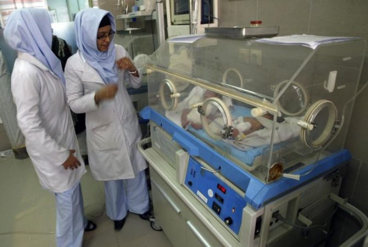 Afghan midwives look at newborn babies at the Razai Foundation Maternity Hospital in Herat province November 30, 2011.