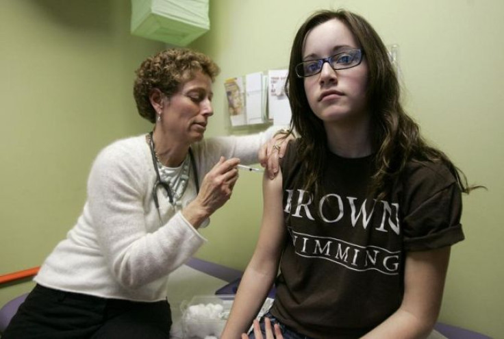 Nancy Brajtbord, RN, (L) administers a shot of gardasil, a Human Papillomavirus vaccine, to a 14-year old patient (who does not wish to be named) in Dallas, Texas March 6, 2007.