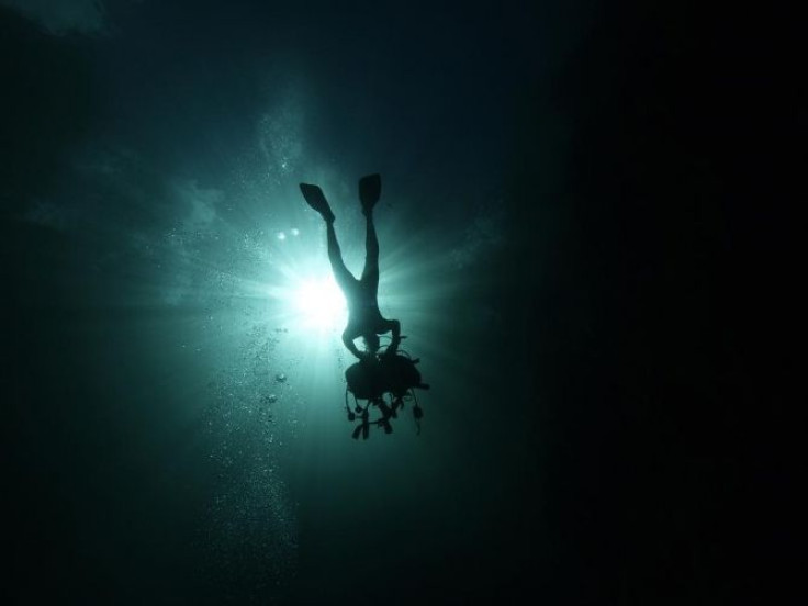 A scuba diver removes his equipment as he prepares to exit La Cueva de los Peces (Cave of the Fish) along the coast of Playa Giron, near the Bay of Pigs, 160 km (100 miles) south-east of Havana, in central Cuba January 24, 2012.