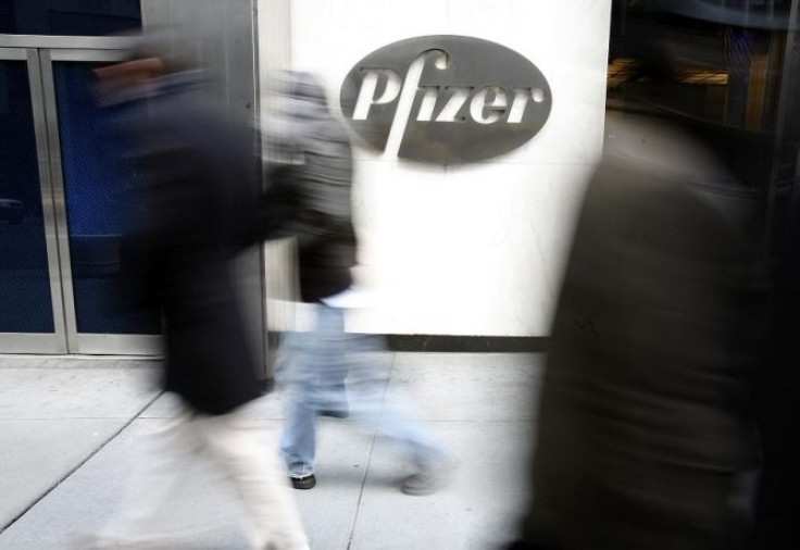 People walk past the Pfizer World headquarters in New York, February 3, 2010.