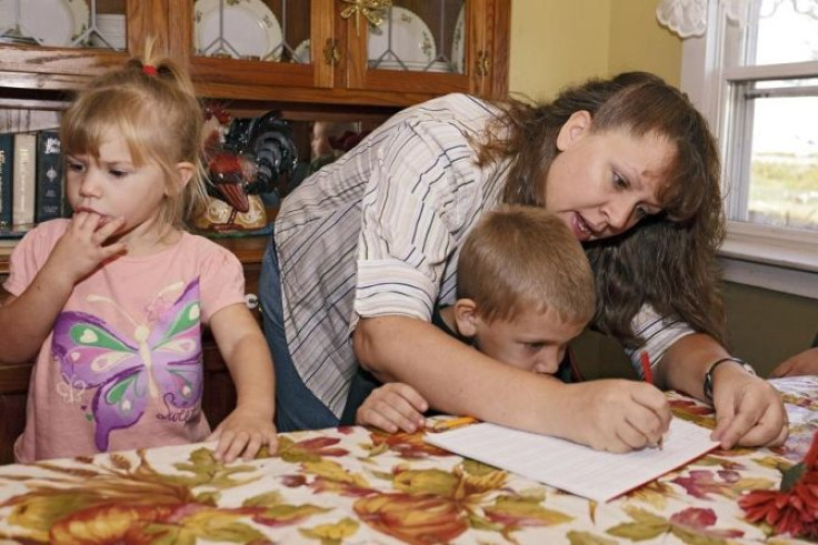 Christa Keagle works with her children Rebekah, 3, and Joshua Keagle, 6, during a homeschool assignment in St. Charles, Iowa September 30, 2011.