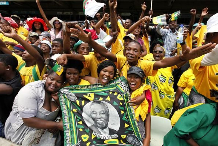 African National Congress (ANC) supporters hold a picture of former South African President Thabo Mbeki during the ANC's centenary celebration in Bloemfontein January 8, 2012.
